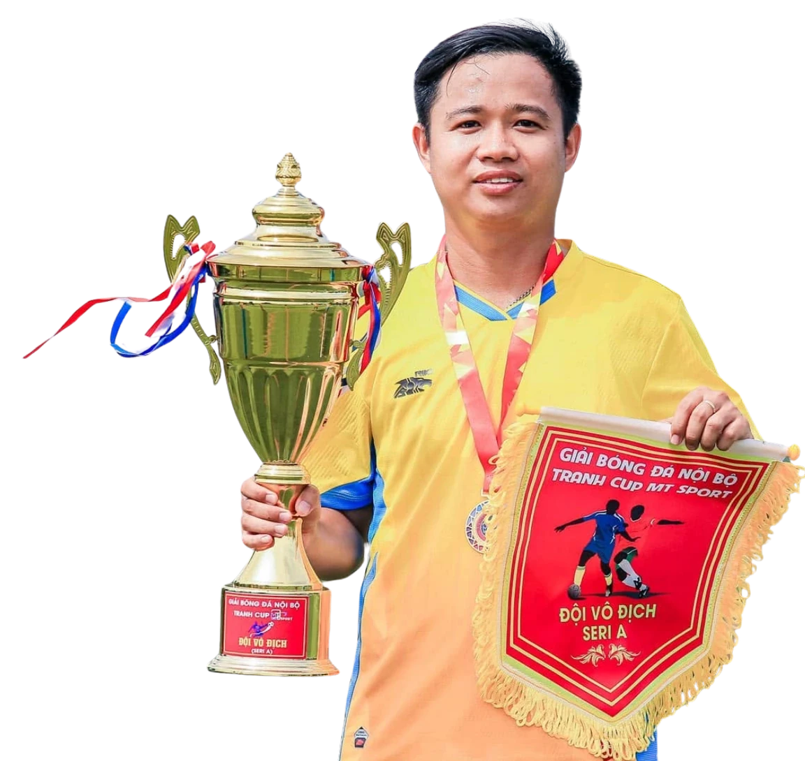 A MIMA team member holding the trophy and champions’ pennant from an internal football tournament
