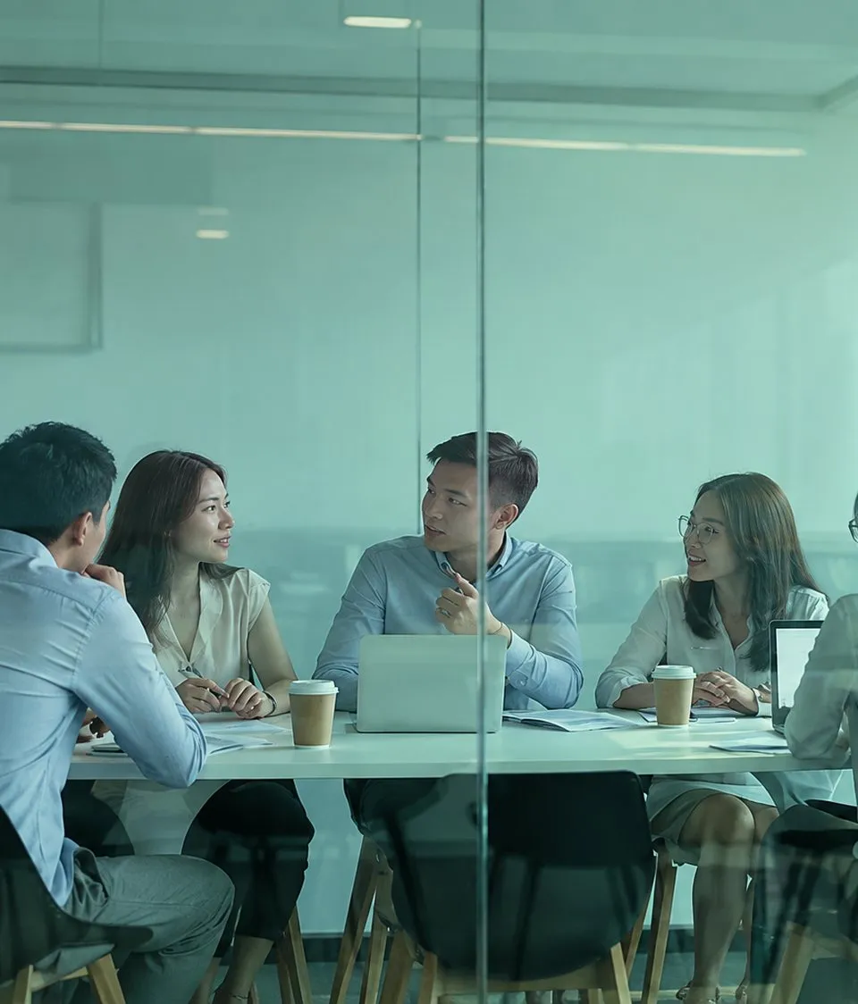 A business team meeting in a glass-walled room