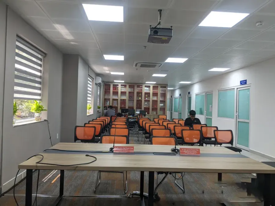 Seminar room set up with a projector, name plates and delegate seating