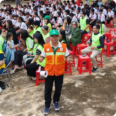 MIMA volunteers with students at a gift-giving event