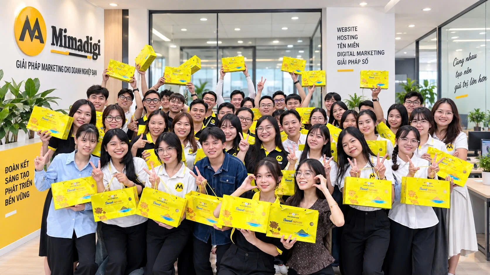 The MIMA team in a group photo at the office for the Mid-Autumn Festival, everyone holding gift boxes and waving